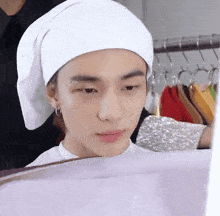 a young man wearing a white towel on his head