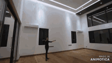 a woman stands in an empty room with the words made in animatica on the bottom