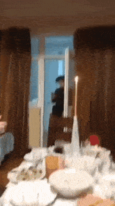 a candle is lit on a table in a room