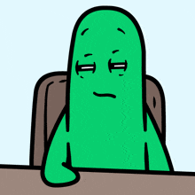 a green cartoon character is sitting at a table with his hand on the table
