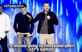 a group of men are standing next to each other on a stage and talking into microphones .