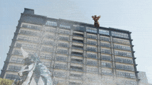 a man on a motorcycle is flying through the air above a building