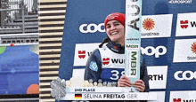 a picture of a woman holding a ski with the name selina freitag on it