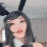 a woman with long hair and bunny ears is making a face