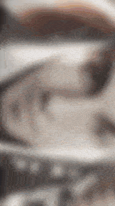 a blurred image of a gray surface with a few spots of light on it