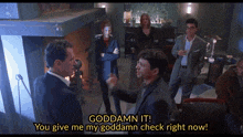 a group of people are gathered in a room and one of them says " goddamn it "