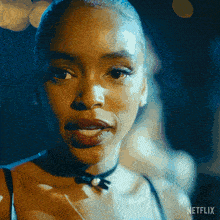 a close up of a woman 's face with the word netflix on the bottom right