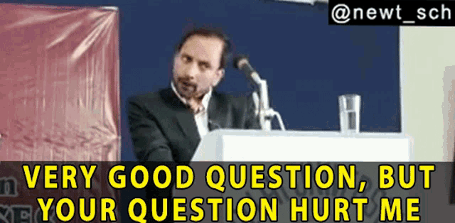 a man stands at a podium with the words 