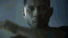 a close up of a man 's face with a hand in his mouth