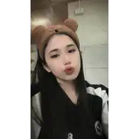 a woman wearing a headband with teddy bear ears takes a selfie