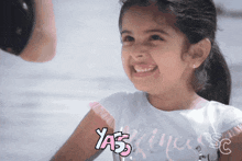 a little girl wearing a shirt that says yas princess