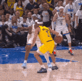 a basketball player wearing a yellow jersey with the number 7