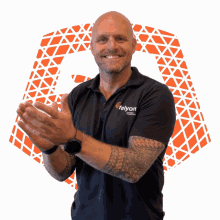 a man wearing a felyon shirt is clapping