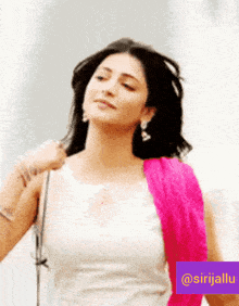 a woman wearing a white top and a pink scarf has a purple sticker that says @sirjallu on it