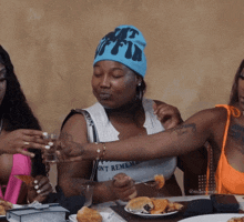 a woman wearing a hat that says " i 'm a bitch "
