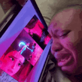 a person is crying while looking at a picture of a woman