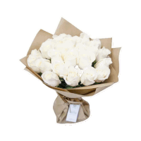 a bouquet of white roses wrapped in brown paper on a white surface .