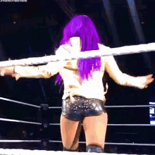a woman with purple hair is in a wrestling ring with the hashtag #thenextbigthing