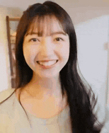 a close up of a woman 's face with a smile on her face .