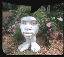 a statue of a woman 's head with flowers on it