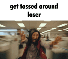 a woman is running in an office with the words get tossed around loser on the bottom