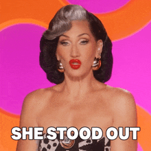a woman says she stood out in front of a pink background
