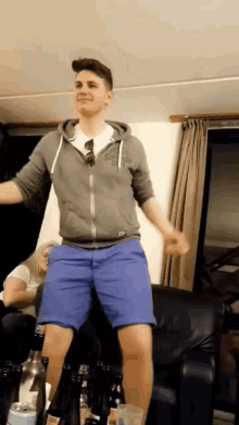 a man wearing a superdry hoodie is dancing