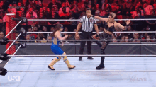 a female wrestler is kicking another wrestler in the face during a wrestling match