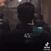 a man wearing a red vest with the number 456 on it