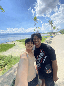 a man wearing a t-shirt that says " school clothing " poses with a girl