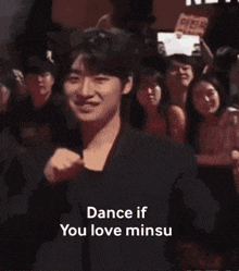 a man in a suit is standing next to another man with the words dance if you love minus on the bottom