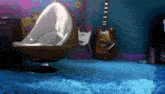 a room with two guitars and a chair in it