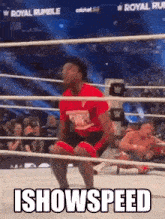 a man is kneeling in a wrestling ring with the words `` i showspeed '' written on it .