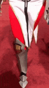 a person wearing a costume is walking on a red carpet .