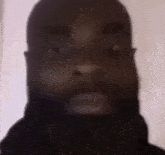 a man with a beard is making a funny face in a blurry photo .