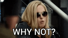 a woman wearing sunglasses and a black jacket is asking why not ?