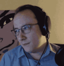 a man wearing glasses and headphones looks at something