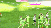 a group of female soccer players on a field with a flyeralarm sign behind them