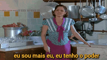 a woman in a kitchen with the words eu sou mais eu eu tenho o poder