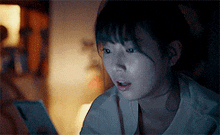 a woman is looking at a cell phone in a dark room .