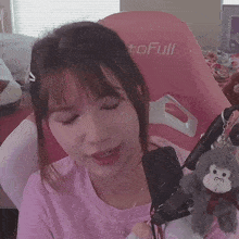 a woman is sitting in a pink chair that says tofull on it