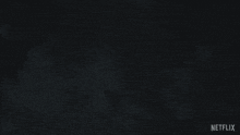 a red and white striped background with netflix written on the bottom