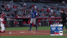 a blue jays baseball player runs to home plate