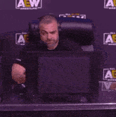 a man sitting in front of a computer with the name odie kingston on the bottom right
