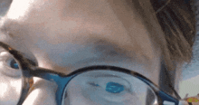 a close up of a person 's face with glasses