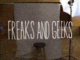 a sign that says freaks and geeks in white letters