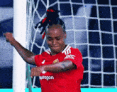 a soccer player wearing a red shirt that says kpdragon