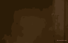 a man with a bloody head is peeking out from behind a door .