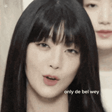 a close up of a woman 's face with the words `` only de bel wey '' written below her .