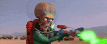 martian from mars attacks the earth is holding a green water gun in his hand .